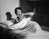 Young woman lying on the bed looking afraid Poster Print - Item # VARSAL25527465