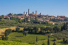 San Gimignano, Siena Province, Tuscany, Italy. Fields surrounding the medieval town famous for its towers. The historic centre of San Gimignano is a UNESCO World Heritage Site. Poster Print by Panoramic Images - Item # VARPPI170283