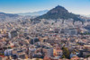 Athens, Attica, Greece. View over Athens from the Acropolis to 277 meter high Mount Lycabettus crowned by the Chapel of St. George. Poster Print by Panoramic Images - Item # VARPPI174269