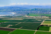 Aerial view of Oxnard farm fields in spring with Ventura City and Pacific Ocean in background, Ventura County, CA Poster Print by Panoramic Images - Item # VARPPI181675