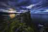Man standing on top of a sea cliff at sunset along Iceland's Strandir Coast in the West Fjord region; Iceland Poster Print by Robert Postma / Design Pics - Item # VARDPI12319551