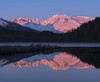 Mountains glowing pink at sunrise and silhouetted forest reflected in a tranquil lake; Juneau, Alaska, United States of America Poster Print by John Hyde / Design Pics - Item # VARDPI12307032