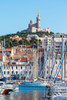 Marseille, Provence-Alpes-Cote d'Azur, France. View across Vieux-Port, the Old Port, to the 19th century Neo-Byzantine Basilica of Notre-Dame de la Garde. Poster Print by Panoramic Images - Item # VARPPI170249