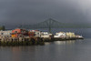 Sunlight warms the riverfront with storm clouds over the Astoria-Megler bridge; Astoria, Oregon, United States of America Poster Print by Robert L. Potts / Design Pics - Item # VARDPI12304882