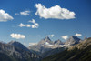 Mountain range with fluffy clouds and blue sky, Banff National Park; Banff, Alberta, Canada Poster Print by Michael Interisano / Design Pics - Item # VARDPI12318957
