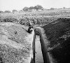 India: Malaria Prevention. /Na Boy Seated Near An Irrigation Ditch In India, Lined With Concrete To Deter Malaria Mosquitos. Photograph, C1929. Poster Print by Granger Collection - Item # VARGRC0123674