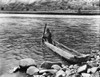 Nez Perc_ Canoe, C1910. /Na Nez Perc_ Native American Holding A Pole And Maneuvering A Dugout Canoe To The Rocky Shore Of The Columbia River. Photograph By Edward S. Curtis, C1910. Poster Print by Granger Collection - Item # VARGRC0125760