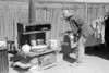 New Mexico: Homesteader. /Nmrs. Faro Caudill Pouring Water Over Milk Bucket To Keep The Milk Cold Outside Of Her Temporary Home In Pie Town, New Mexico. Photograph By Russell Lee, 1940. Poster Print by Granger Collection - Item # VARGRC0352596