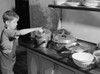 Thanksgiving, 1940. /Na Young Boy Inspects A Pot Of Pudding Cooking On The Stove For Thanksgiving Dinner, At His Home In Ledyard, Connecticut. Photograph By Jack Delano, November 1940. Poster Print by Granger Collection - Item # VARGRC0123256