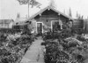 Alaska: Log Cabin. /Na Log Cabin With An Attached Greenhouse And A Large Flower Garden In The Front Yard In Nome, Alaska. Photograph, C1900-1923. Poster Print by Granger Collection - Item # VARGRC0124349