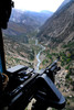 An aerial gunner surveys the surrounding area during a combat mission in Afghanistan Poster Print by Stocktrek Images - Item # VARPSTSTK105129M