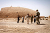 A Georgian Army soldier interacts with Afghan children Poster Print by Stocktrek Images - Item # VARPSTSTK107907M