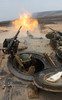 A tank crewman braces himself after firing a 120mm round from a M1A1 Abrams battle tank Poster Print by Stocktrek Images - Item # VARPSTSTK103569M