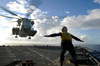 Aviation Boatswain's Mate directs a CH-53E Super Stallion onto the flight deck of USS Harpers Ferry Poster Print by Stocktrek Images - Item # VARPSTSTK103878M