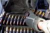 A soldier reaches for a belt of 50 caliber ammunition Poster Print by Stocktrek Images - Item # VARPSTSTK101742M