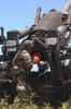 Soldier loads a charge round behind the ammunition round of the Howitzer 150 gun Poster Print by Stocktrek Images - Item # VARPSTSTK100576M