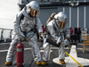 Firemen confirm a simulated fire is extinguished on the flight deck of USS Chosin Poster Print by Stocktrek Images - Item # VARPSTSTK106346M