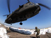 Specialists attach cargo hooks supporting large bags of sand to a CH-47 Chinook helicopter Poster Print by Stocktrek Images - Item # VARPSTSTK100215M