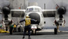 An aircraft director guides a C-2A Greyhound aircraft across the flight deck Poster Print by Stocktrek Images - Item # VARPSTSTK103379M