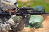 US Army Soldier fires at a target with a M4 carbine rifle Poster Print by Stocktrek Images - Item # VARPSTSTK108678M
