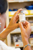 A female pharmacist examining a vial in a pharmacy Poster Print by National Institutes of Health/Stocktrek Images - Item # VARPSTNIH700052H