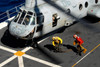 Sailors chock and chain a CH-46E Sea Knight helicopter Poster Print by Stocktrek Images - Item # VARPSTSTK106928M