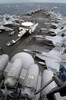 Sailors move an E-2C Hawkeye down the crowded flight deck aboard USS Kitty Hawk Poster Print by Stocktrek Images - Item # VARPSTSTK101012M