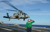 Airman salutes as a MH-60S Sea Hawk helicopter departs Poster Print by Stocktrek Images - Item # VARPSTSTK108338M