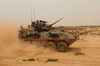 A Marine Corps Light Armored Vehicle kicks up a cloud of dust Poster Print by Stocktrek Images - Item # VARPSTSTK106237M