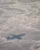 A DC-8 aircraft casts its shadow over the Bering Sea Poster Print by Stocktrek Images - Item # VARPSTSTK102705M