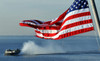 American flag blowing in the wind with a hovercraft in the background Poster Print by Stocktrek Images - Item # VARPSTSTK104602M