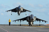 An AV-8B Harrier prepares for takeoff as another lands aboard USS Makin Island Poster Print by Stocktrek Images - Item # VARPSTSTK104373M