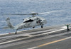 A Sailor directs an MH-60S Sea Hawk to land on the flight deck of USS Carl Vinson Poster Print by Stocktrek Images - Item # VARPSTSTK108308M