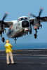 A US Navy officer observes a C-2A Greyhound aircraft landing onboard USS Harry S Truman Poster Print by Stocktrek Images - Item # VARPSTSTK100037M