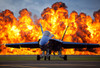 A wall of fire erupts behind a US Navy F/A-18 Hornet aircraft Poster Print by Stocktrek Images - Item # VARPSTSTK106832M
