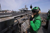 Aviation Boatswain??s Mate signals to a shooter as an F/A-18E Super Hornet prepares to launch Poster Print by Stocktrek Images - Item # VARPSTSTK106927M