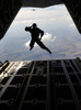 A paratrooper salutes as he jumps out of a C-130J Super Hercules Poster Print by Stocktrek Images - Item # VARPSTSTK104237M