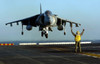 Aviation Boatswain's Mate directs an AV-8B Harrier as it lands on the flight deck of USS Peleliu Poster Print by Stocktrek Images - Item # VARPSTSTK100262M