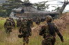 Marines approach a landing zone for extraction as a CH-53D Sea Stallion helicopter awaits them Poster Print by Stocktrek Images - Item # VARPSTSTK100586M