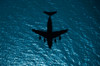 Silhouette of a military aircraft in flight over the Atlantic Ocean Poster Print by Stocktrek Images - Item # VARPSTSTK103768M
