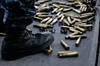 Shell casings from a 50 caliber machine gun around the feet of a soldier Poster Print by Stocktrek Images - Item # VARPSTSTK105560M