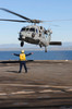 Boatswain??s Mate directs an MH-60S Sea Hawk helicopter on the flight deck of USS Comstock Poster Print by Stocktrek Images - Item # VARPSTSTK104057M