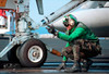 Airman guides an F/A-18 Hornet onto the catapult aboard USS George Washington Poster Print by Stocktrek Images - Item # VARPSTSTK100031M