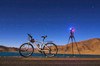 A camera, tripod and bicycle on a full moon night at Yamdrok Lake, Tibet, China Poster Print by Jeff Dai/Stocktrek Images - Item # VARPSTJFD200045S