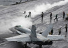 An F/A-18C Hornet taxies to a steam-powered catapult on the flight deck of USS Theodore Roosevelt Poster Print by Stocktrek Images - Item # VARPSTSTK100205M