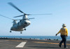 A CH-46E Sea Knight helicopter prepares to land on the flight deck of USS Makin Island Poster Print by Stocktrek Images - Item # VARPSTSTK105890M