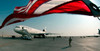 The wind blows the US flag over the top of the DC-10 rotator aircraft Poster Print by Stocktrek Images - Item # VARPSTSTK101068M