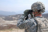 Soldier observes an adjust fire mission through binoculars Poster Print by Stocktrek Images - Item # VARPSTSTK105946M