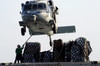 An MH-60S Sea Hawk picks up supplies from the flight deck of USNS Bridge Poster Print by Stocktrek Images - Item # VARPSTSTK106709M