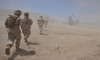 Marines move through a dust cloud toward a CH-46 Sea Knight Poster Print by Stocktrek Images - Item # VARPSTSTK106233M